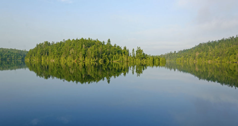 Morning reflections on emerald lake in the quetico