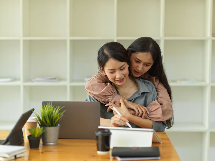 Female entrepreneurs using digital tablet at home