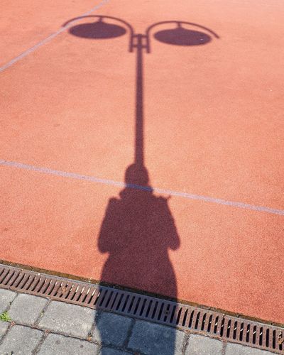 Shadow of woman on sports court