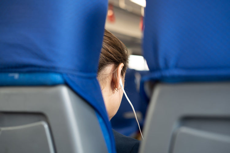 Woman listening music in airplane
