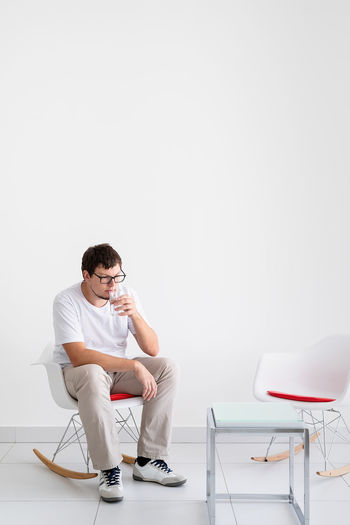 Mental health and healthcare. young depressed man with headache sitting on the chair