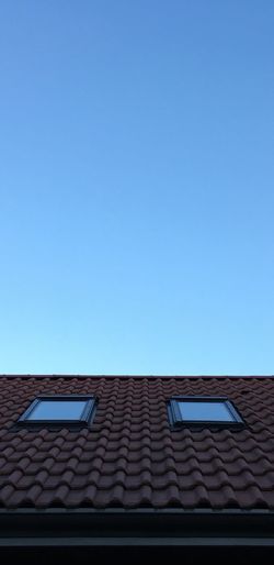 Low angle view of blue roof against clear sky