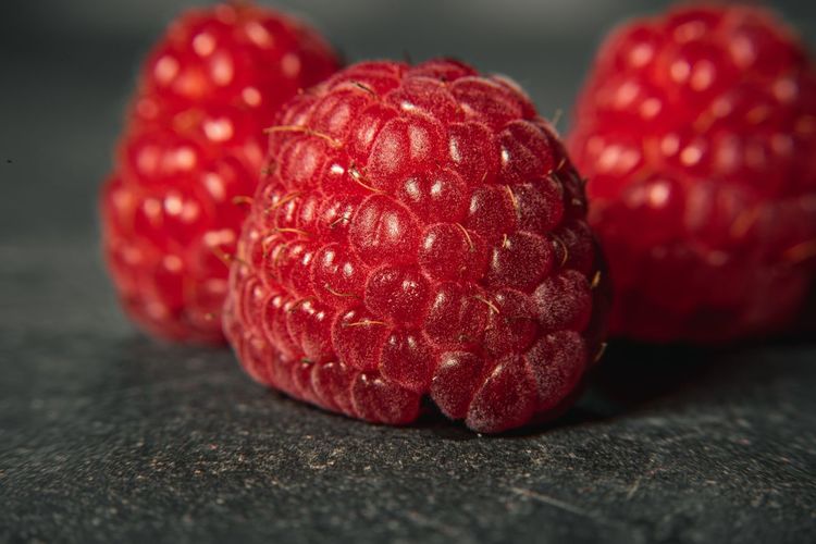 Close-up of red raspberries on table