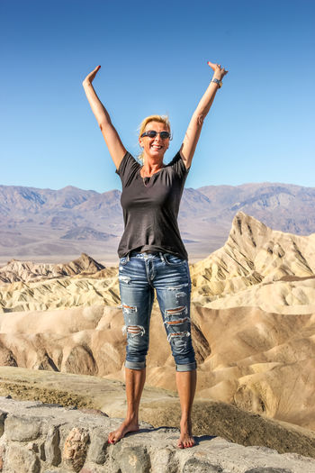 Happy caucasian woman standing at the zabriskie point, death vallkey national park
