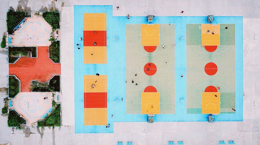 Drone view of people playing on courts