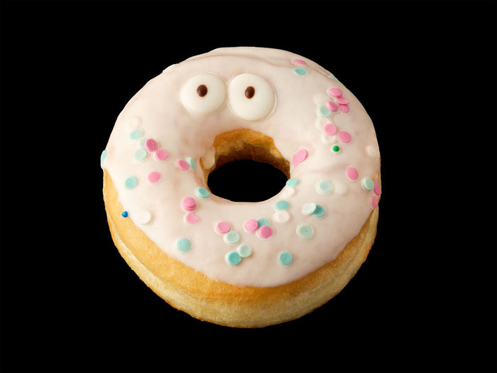 Close-up of donut against black background