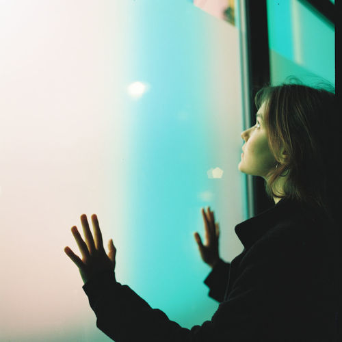 Young woman standing by window