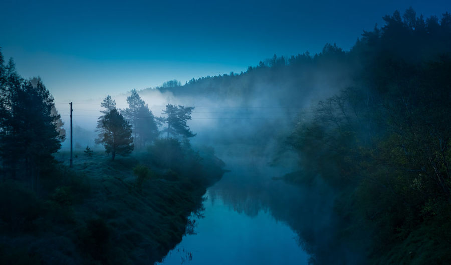 A beautiful spring landscape of a river valley with morning mist. springtime scenery of a river..