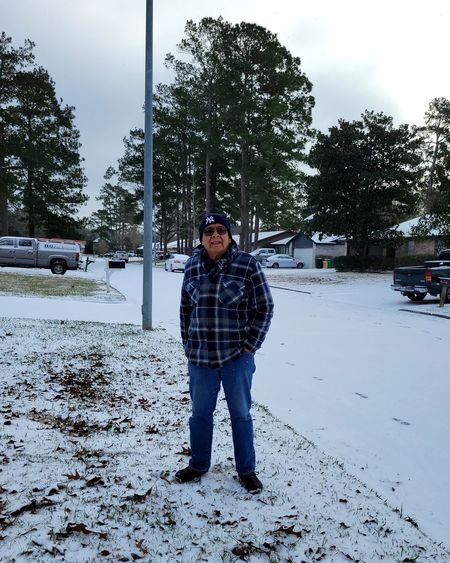 Full length portrait of man standing in snow