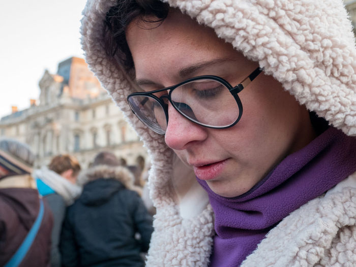 Close of woman wearing glasses on winter season.