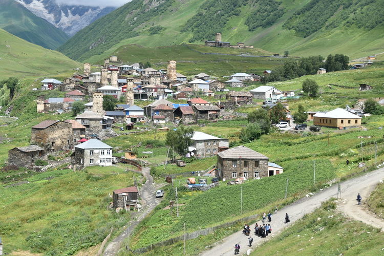High angle view of houses on field by mountain