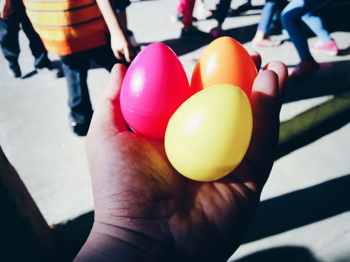 Cropped image of person holding easter eggs