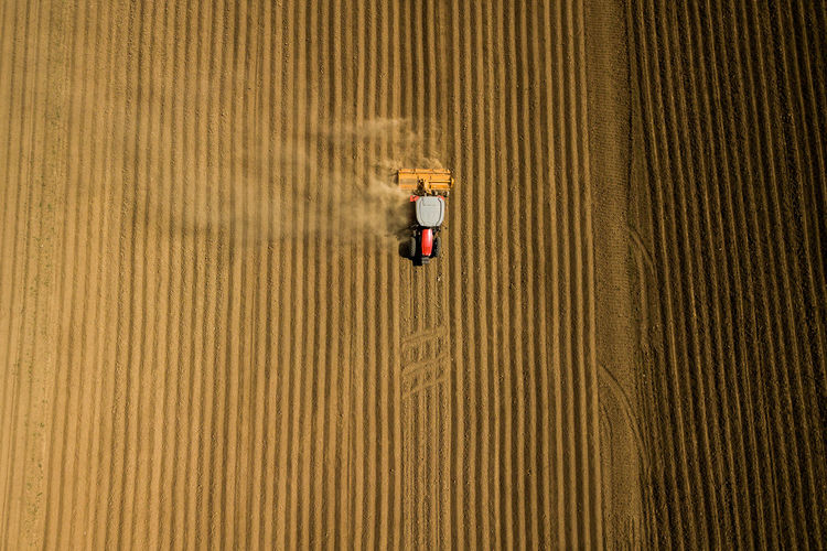 Aerial view of tractor moving on field