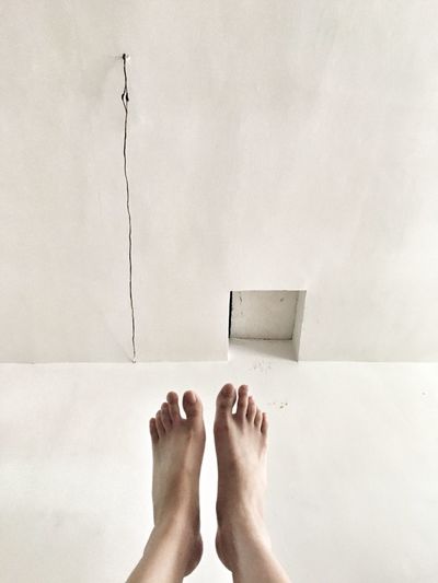 Human feet dangling above floor