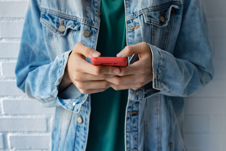 Midsection of man using mobile phone