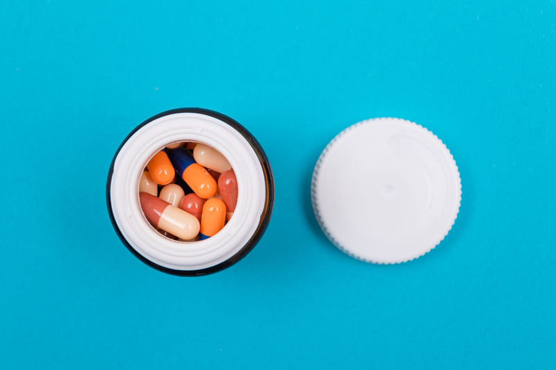 Directly above shot of pills and medicines on blue background