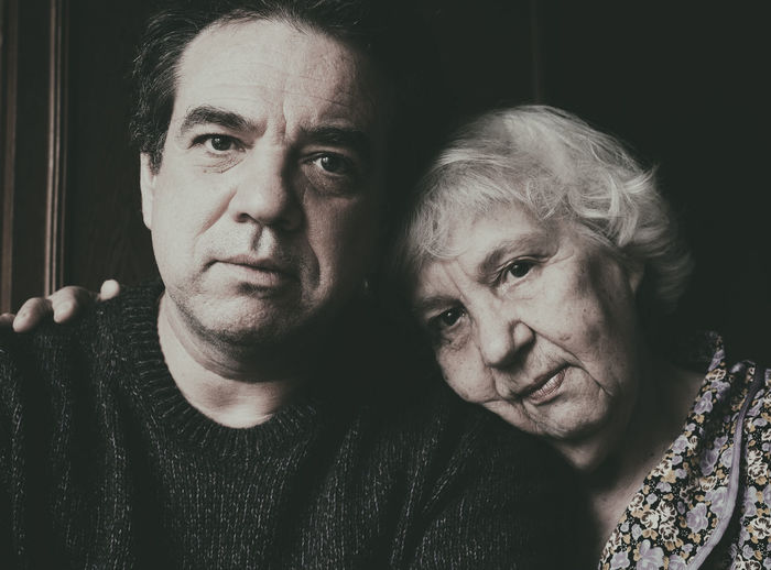 Close-up portrait of mother with son at home