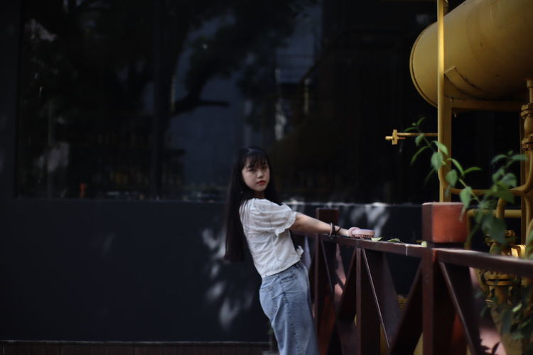 Portrait of girl standing against plants