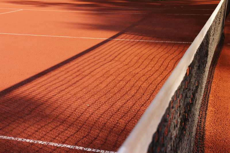 Shadow of net on tennis court