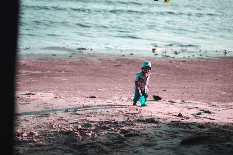Full length of boy playing on beach