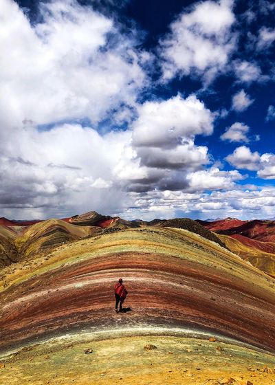 Man riding on field against sky