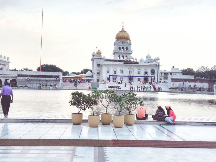 People at gurudwara bangla sahib against sky