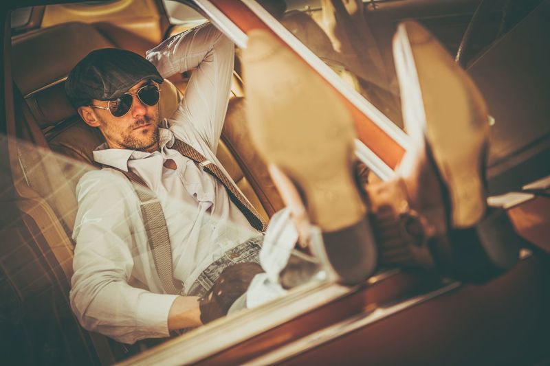 High angle portrait of man sitting in vintage car