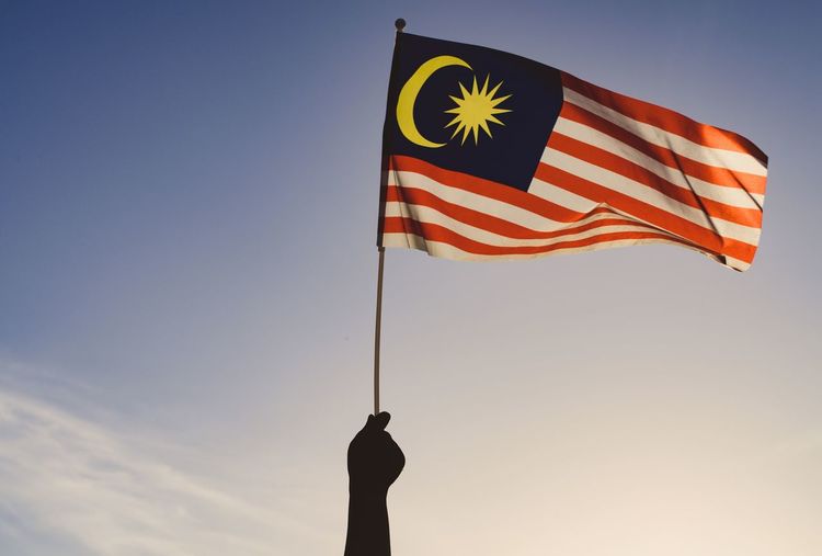 Low angle view of malaysian flag against sky