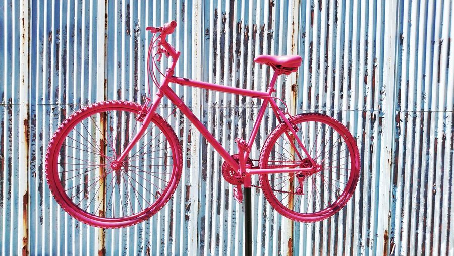 Close-up of bicycle parked against wall