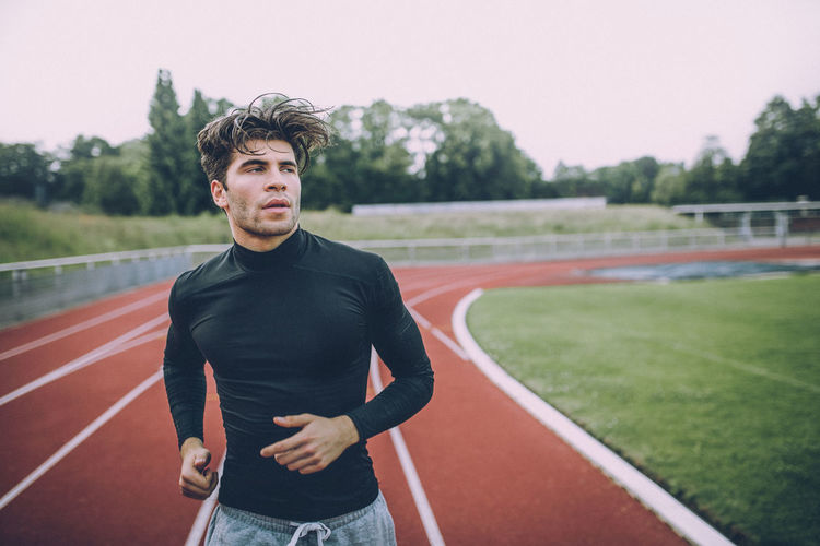 Portrait of young man running outdoors