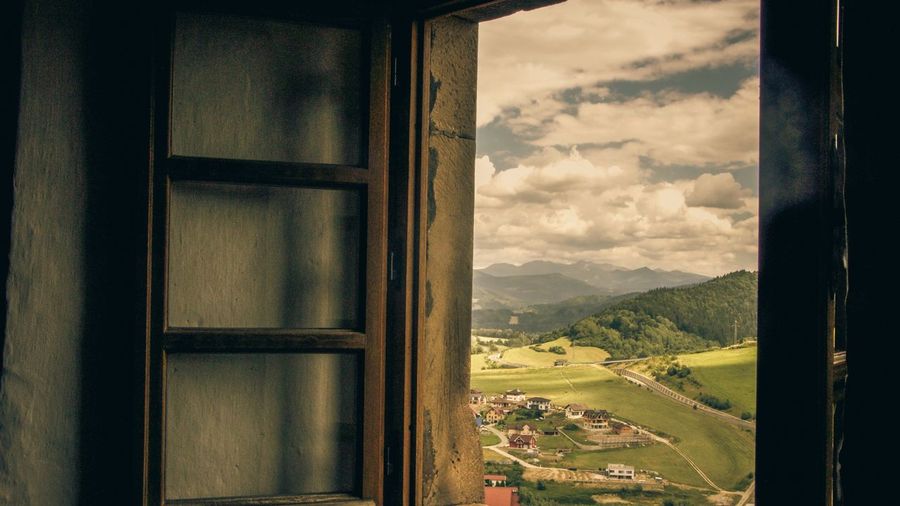 Scenic view of landscape seen through window