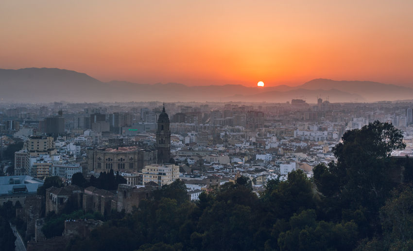 Cityscape against sky during sunset