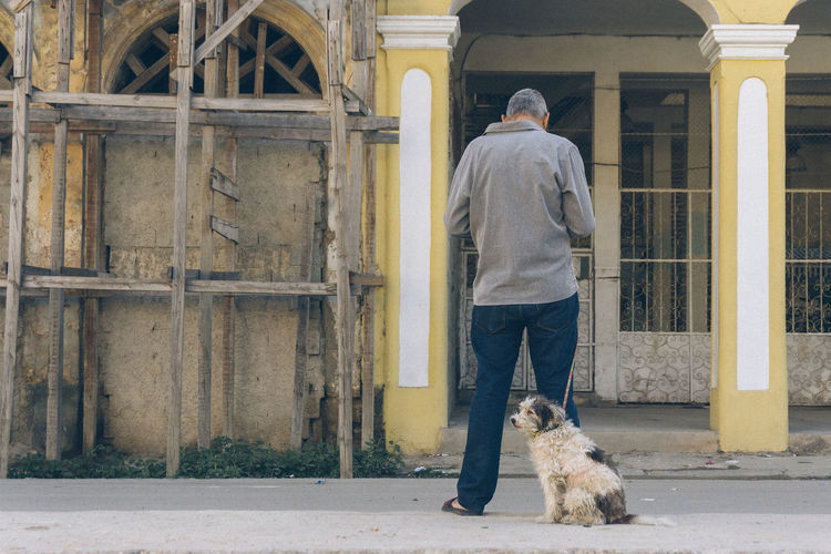 Full length of man standing by dog