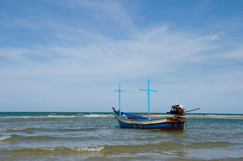 Fishing boat in sea against sky
