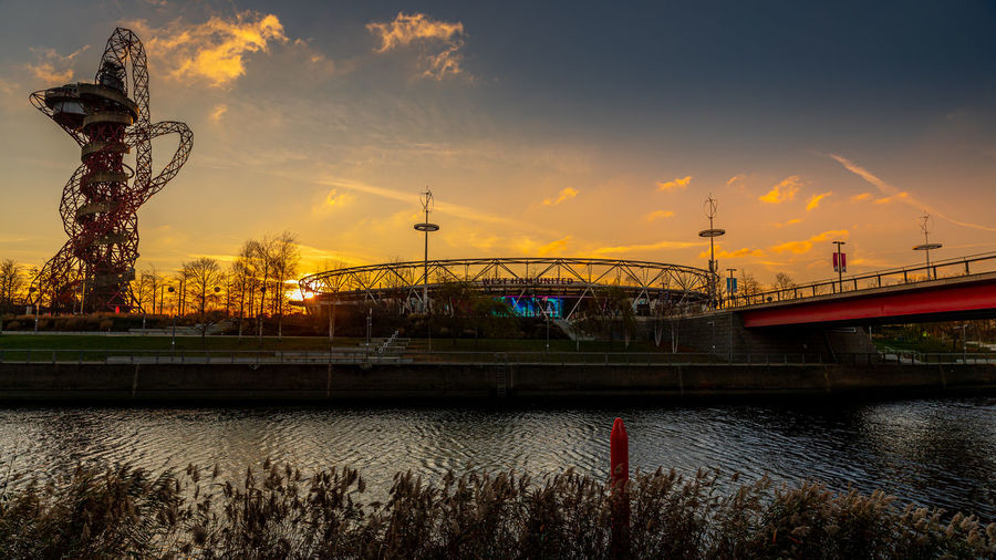 Bridge over river during sunset