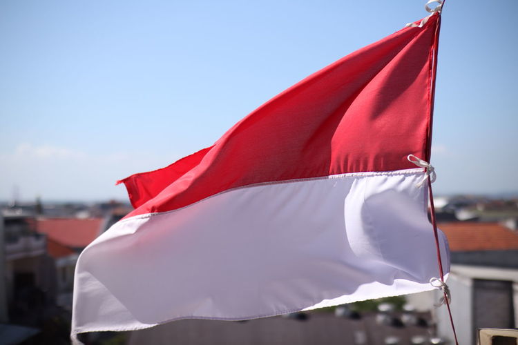 Close-up of red flag against sky, indonesian flag