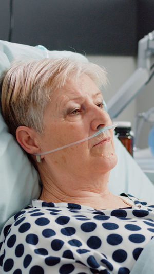 Senior woman resting on bed at hospital