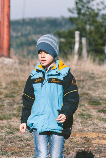 Boy wearing warm clothing on field
