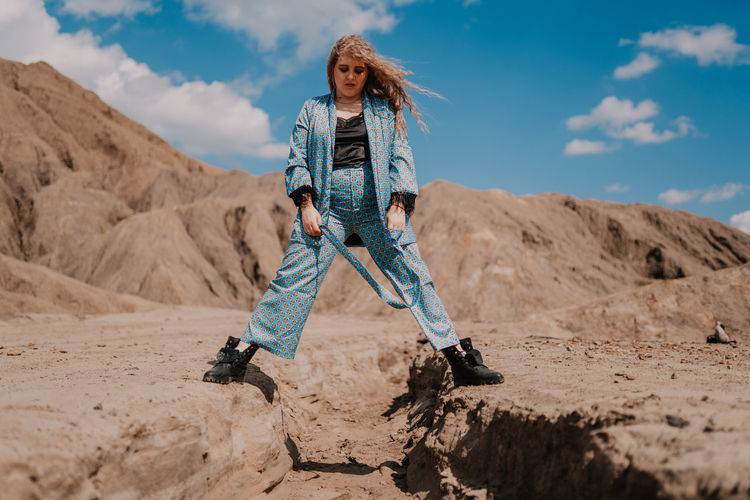 portrait of young woman standing on mountain