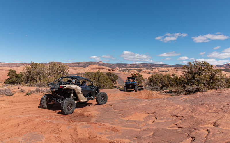 Full frame view of tourists enjoying a 4x4 tour in rugged terrain on a beautiful sunny day