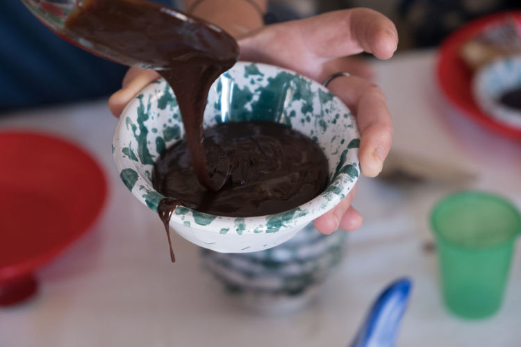 Midsection of man holding ice cream in bowl