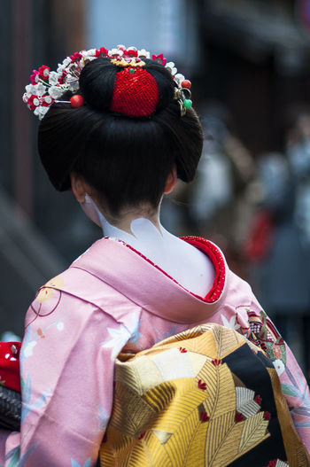 Rear view of girl with red umbrella