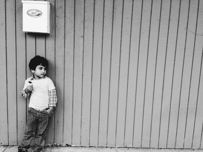 Boy standing against wall