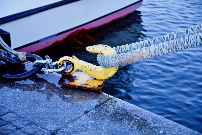 Close-up of rope tied on metal boat