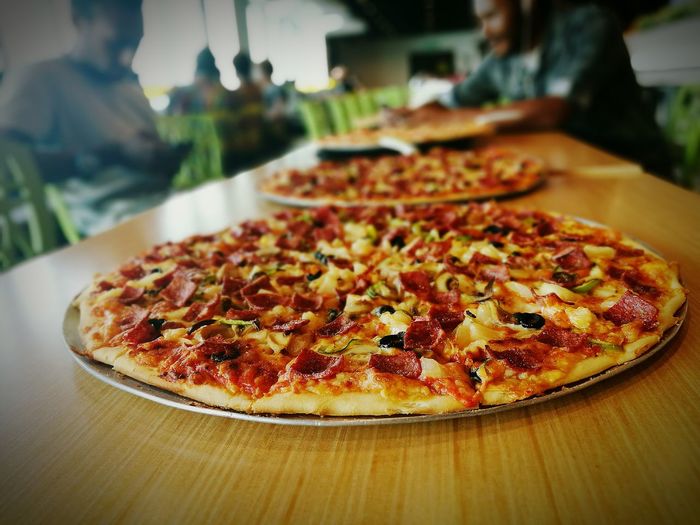 Close-up of pizzas on table
