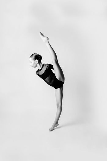 Full length girl standing over white background