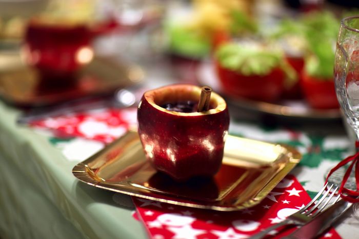 Apple drink served in plate on table during christmas