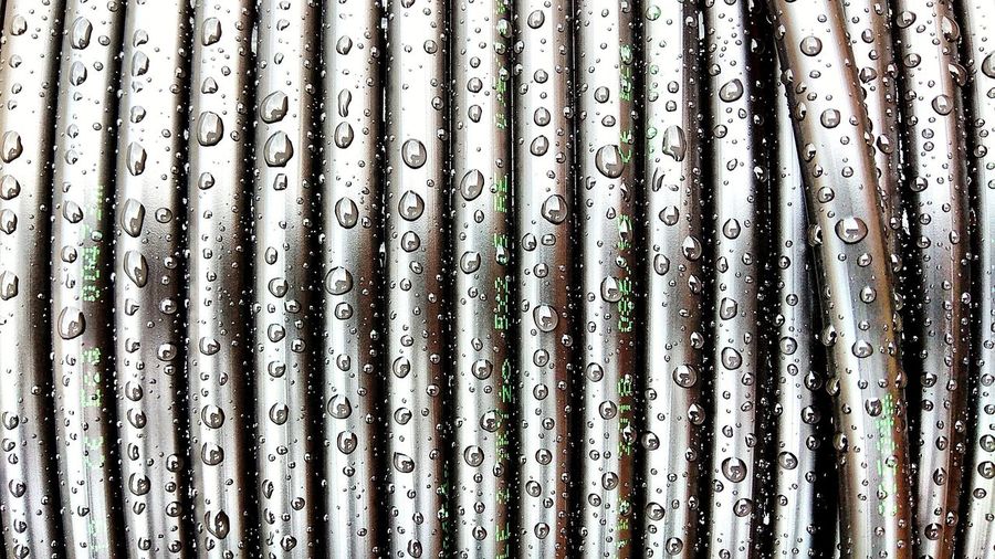Full frame shot of wet metal grate