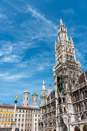 The new city hall at the marienplatz in munich with the towers of the frauenkirche in the back