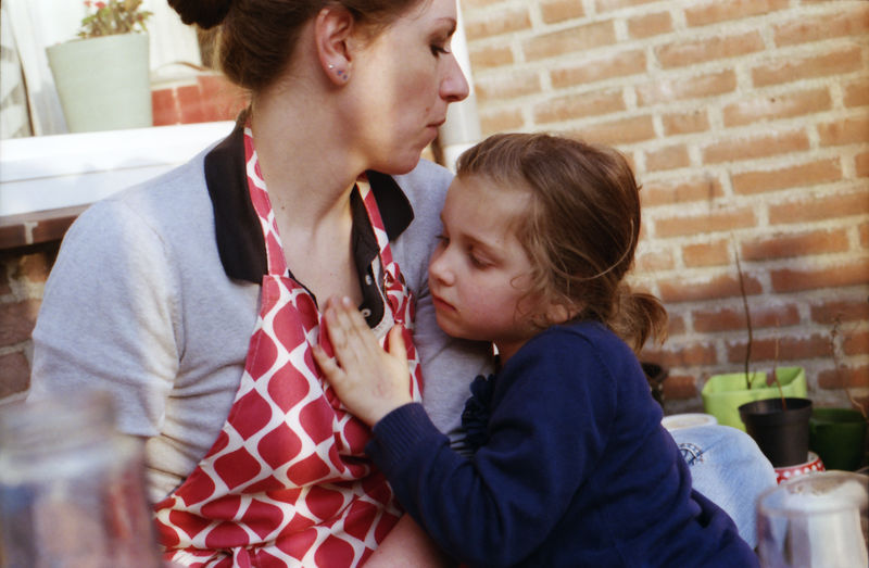 Woman with daughter sitting at home